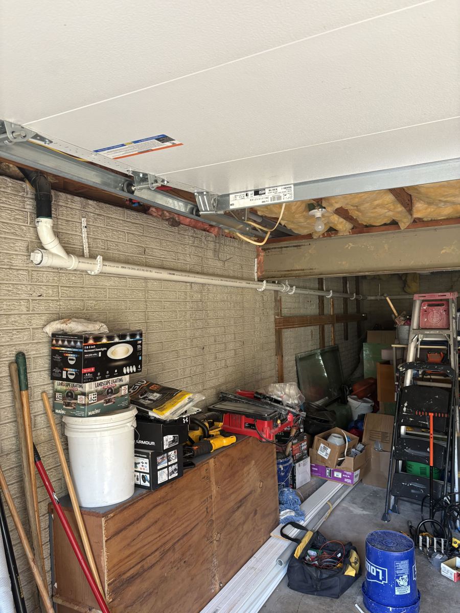 New PVC kitchen drain line rerouted along a garage wall to bypass an old galvanized drain in the slab in Lexington, KY